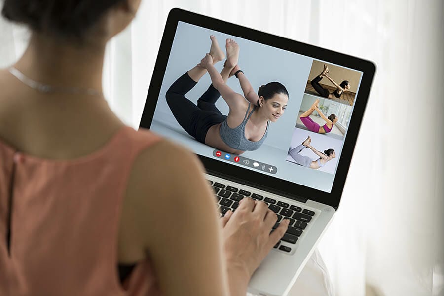 a woman watching a yoga video